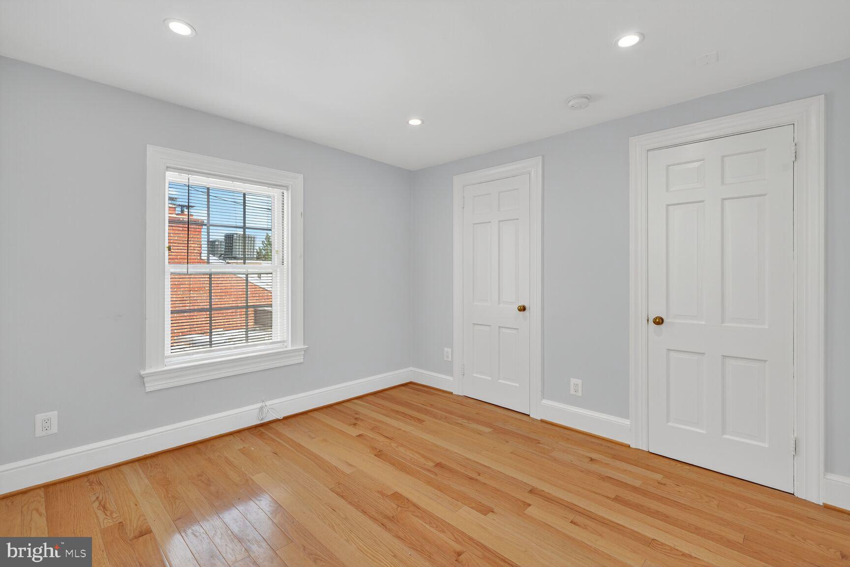 1363 28th Street Northwest, Unit 3 Washington, DC 20007 - Photo 3 of 13 a view of empty room with wooden floor and fan