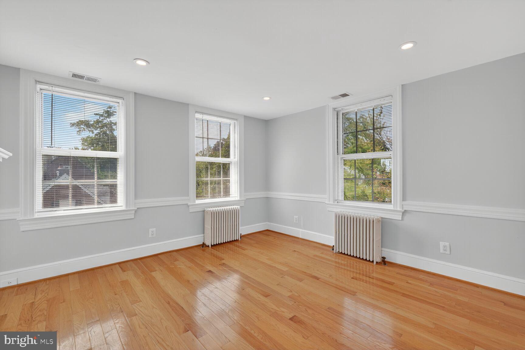 1363 28th Street Northwest, Unit 3 Washington, DC 20007 - Photo 8 of 13 an empty room with wooden floor and windows