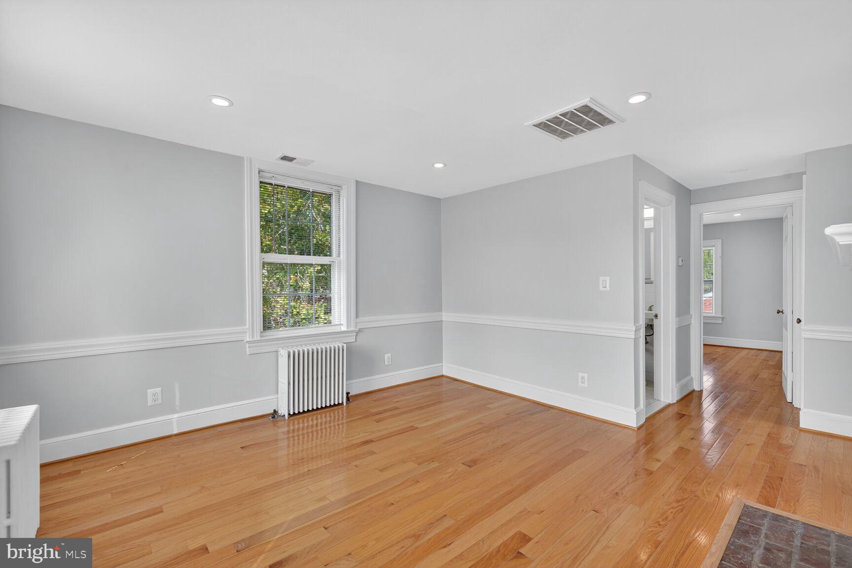 1363 28th Street Northwest, Unit 3 Washington, DC 20007 - Photo 9 of 13 a view of empty room with wooden floor and fan
