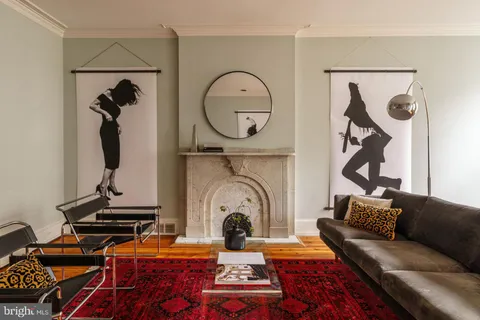 a living room with furniture a rug and a fireplace