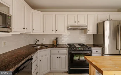 a couple of chairs sitting in backyard of house