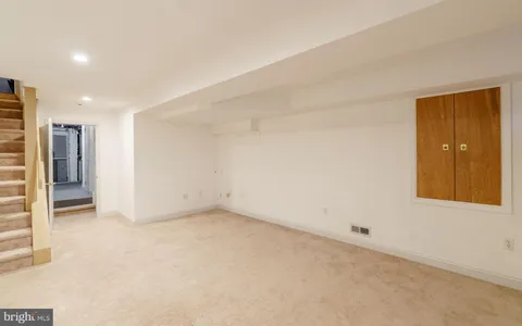 a bathroom with a sink a window and a shower