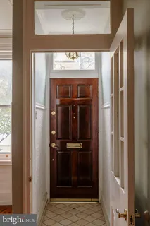 a view of front door with wooden floor