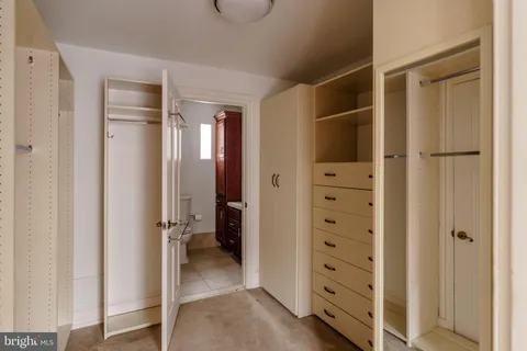 a view of a hallway with wooden floor and windows