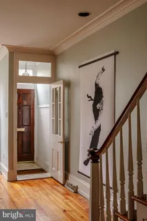a view of entryway with wooden floor and stairs