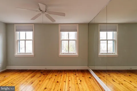 a view of workspace with wooden floor windows and piano