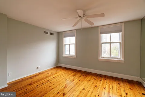 a view of a balcony with wooden floor and fence