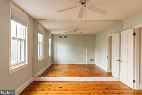 a view of a balcony with wooden floor