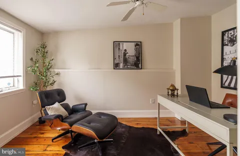 a view of a roof deck with table and chairs and wooden floor