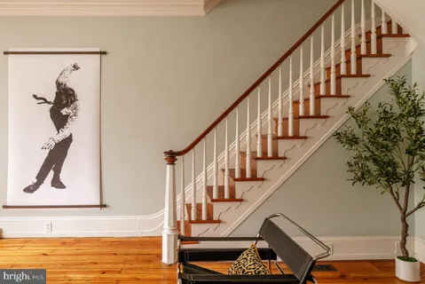 a living room with furniture a flat screen tv and a window