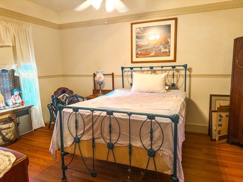 618 West Main Street Fairfield, TX 75840 - Photo 16 of 23 a bedroom with a bed and wooden floor