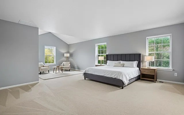 a spacious bedroom with a bed and a couch