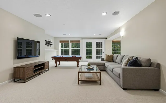 a room with pool table and windows