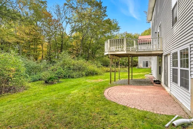 a view of a house with a yard and sitting area