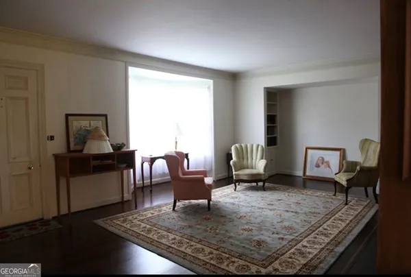 a living room with furniture rug and a window