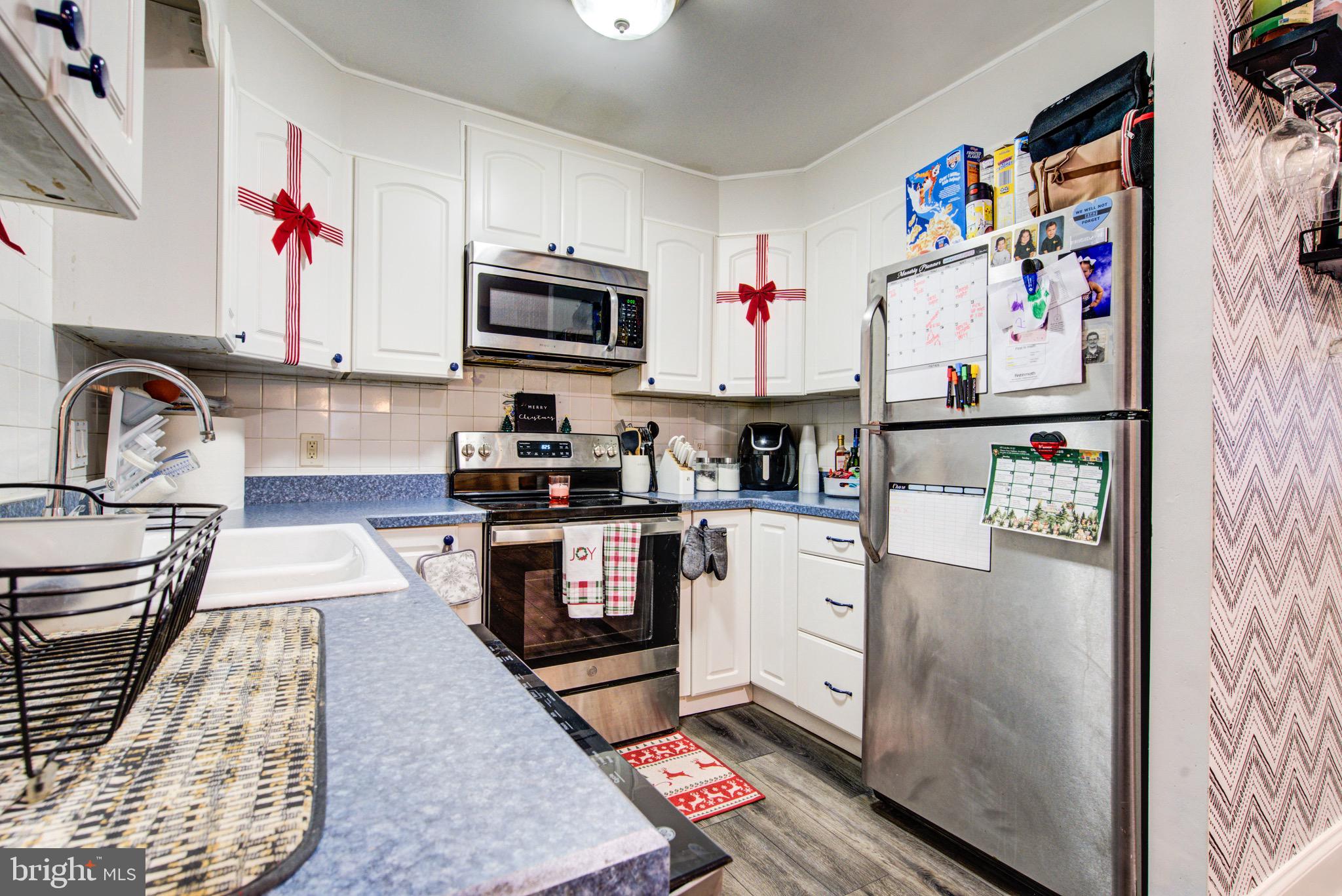 83 Indigo Road Levittown, PA 19057 - Photo 18 of 37 a kitchen with stainless steel appliances granite countertop a refrigerator sink and cabinets