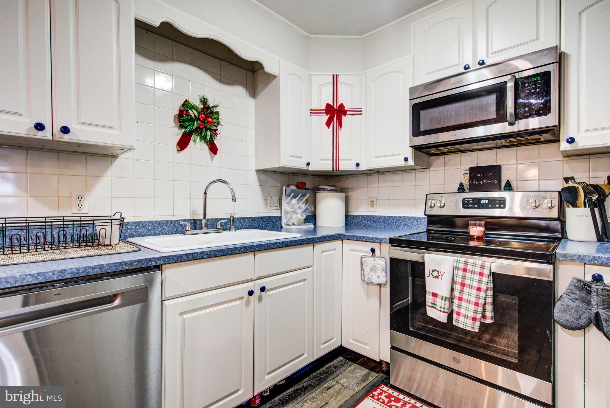 83 Indigo Road Levittown, PA 19057 - Photo 19 of 37 a kitchen with stainless steel appliances granite countertop a sink stove and microwave