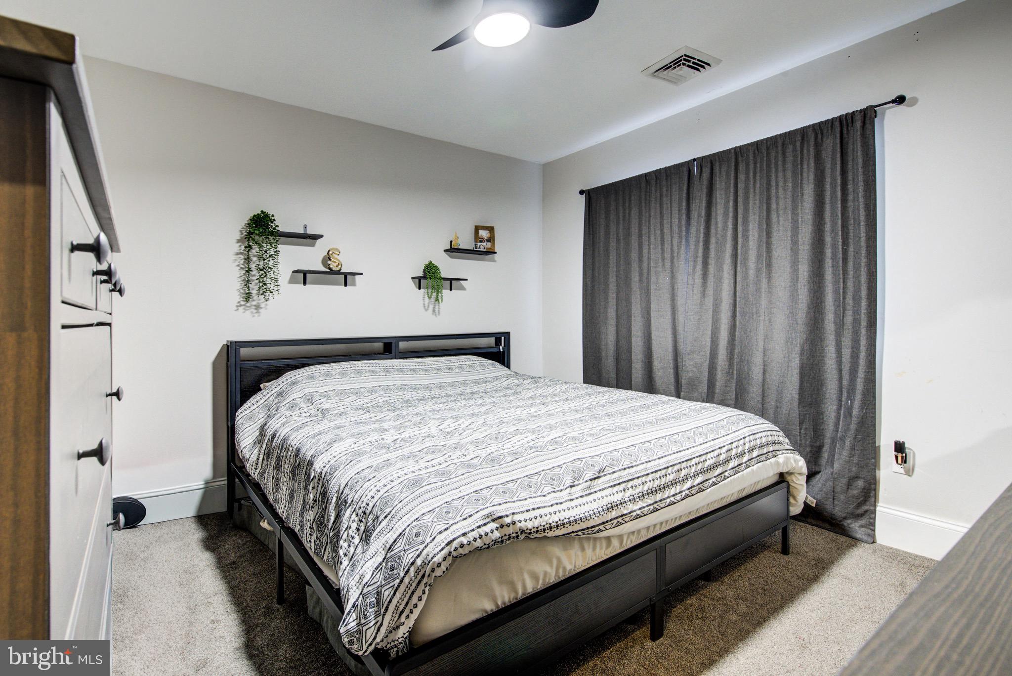 83 Indigo Road Levittown, PA 19057 - Photo 20 of 37 a bedroom with a bed and a chandelier