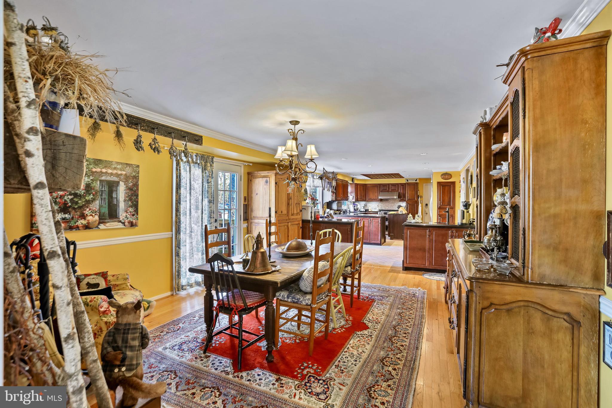 12080 Axline Road Lovettsville, VA 20180 - Photo 13 of 54 a living room with furniture a chandelier and a dining table with wooden floor