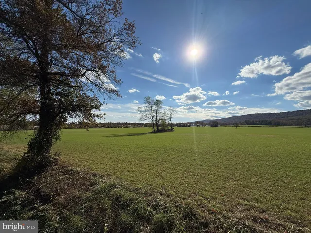 a roof deck with table and chairs under an umbrella