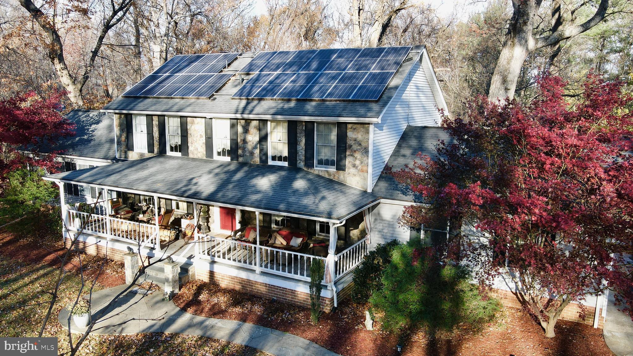 12080 Axline Road Lovettsville, VA 20180 - Photo 38 of 54 a roof deck with table and chairs under an umbrella