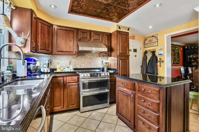 a kitchen with stainless steel appliances kitchen island granite countertop a sink and cabinets
