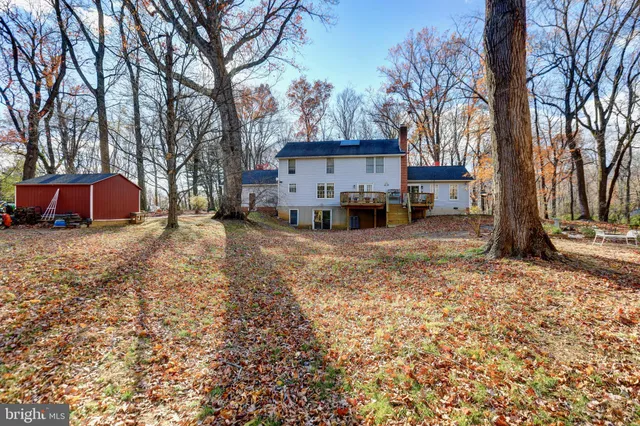 a view of a house with a yard covered in snow