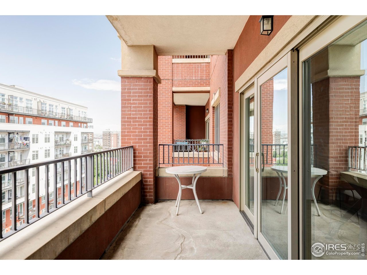 1950 Logan Street, Unit 1013 Denver, CO 80203 - Photo 15 of 23 a view of a balcony with furniture and a window