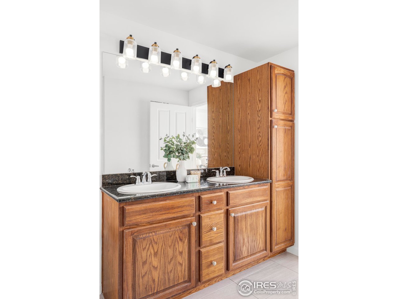 1950 Logan Street, Unit 1013 Denver, CO 80203 - Photo 18 of 23 a bathroom with a sink and a mirror