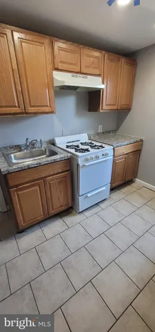 a view of a kitchen with furniture and an empty room