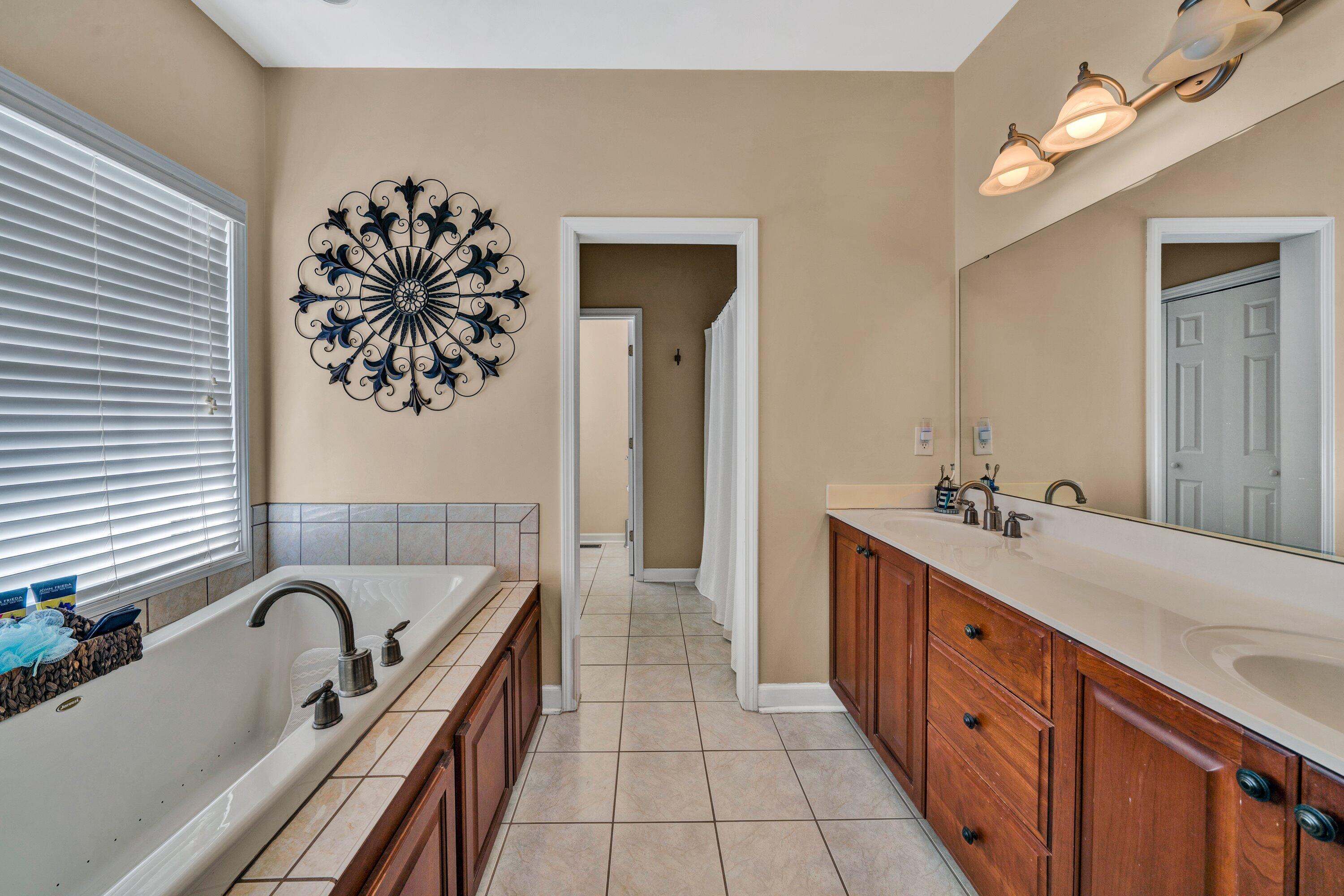 1170 Loggers Road Goodview, VA 24095 - Photo 27 of 55 a bathroom with a tub sink and mirror