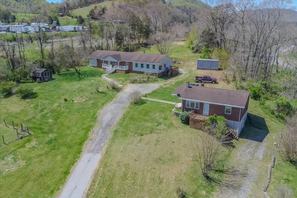 an aerial view of a house with garden space and lake view