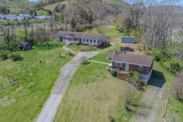 an aerial view of a house with garden space and lake view