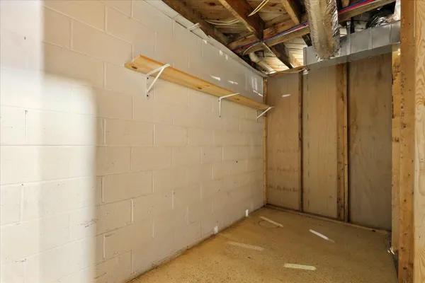 a view of an empty room with wooden floor and windows