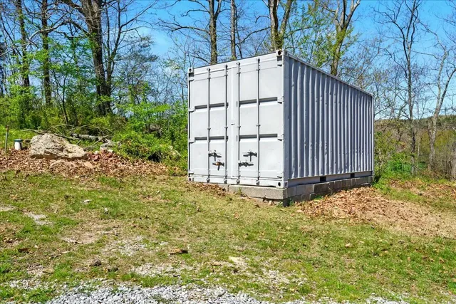 a kitchen with granite countertop a sink a window stainless steel appliances and cabinets