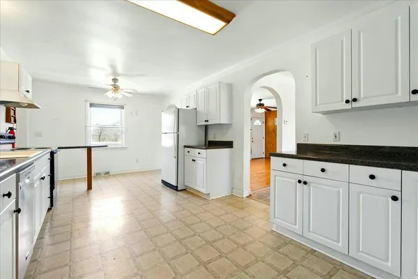 a kitchen with granite countertop a sink cabinets and stainless steel appliances