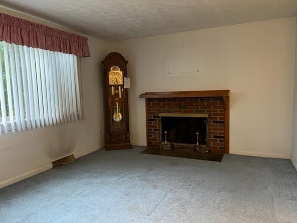 40 Old Bolton Road Hudson, MA 01749 - Photo 3 of 8 a living room with furniture and a fireplace