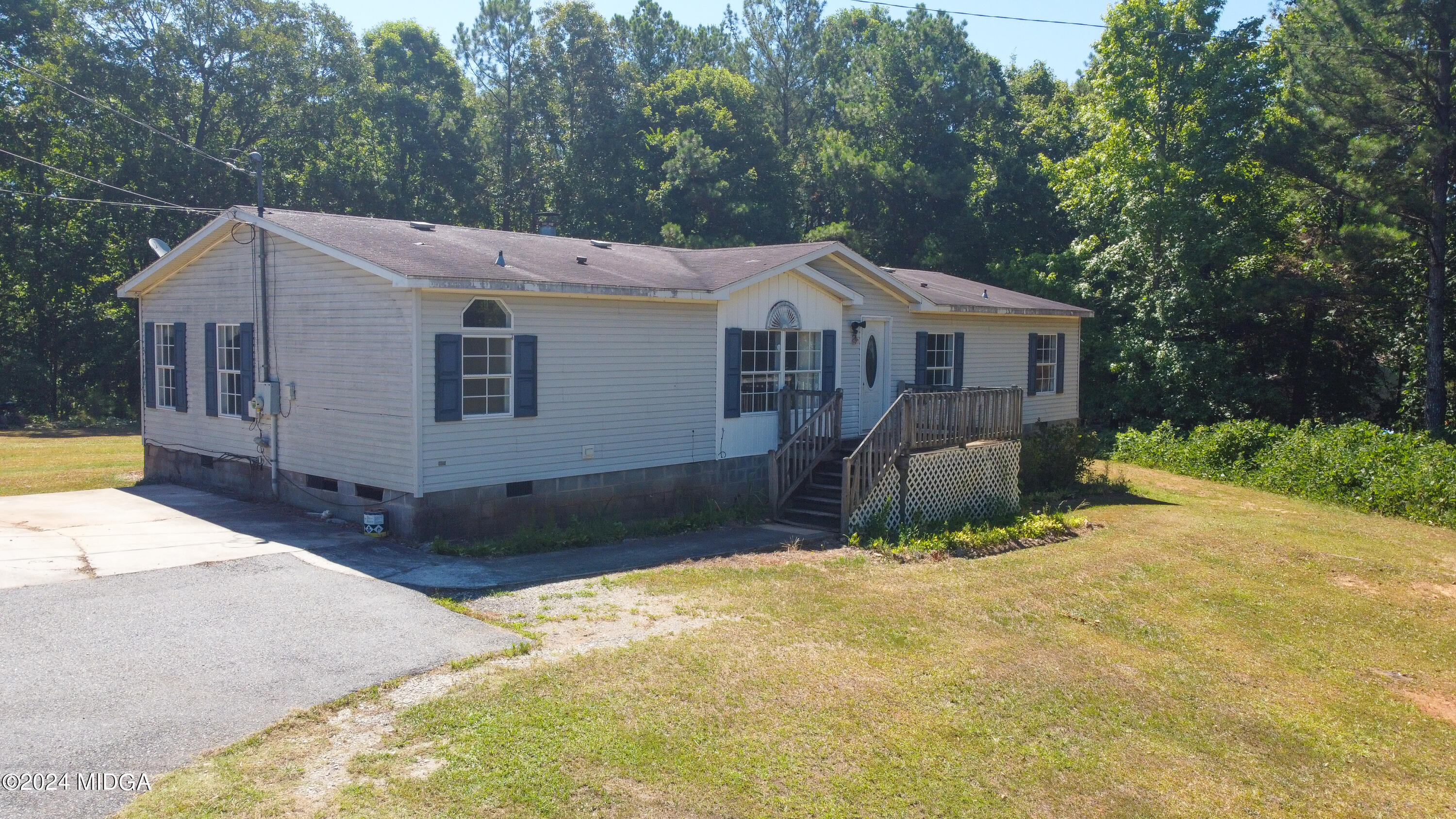 4687 Boxankle Road Jackson, GA 30233 - Photo 1 of 37 a view of a house with a yard and large tree