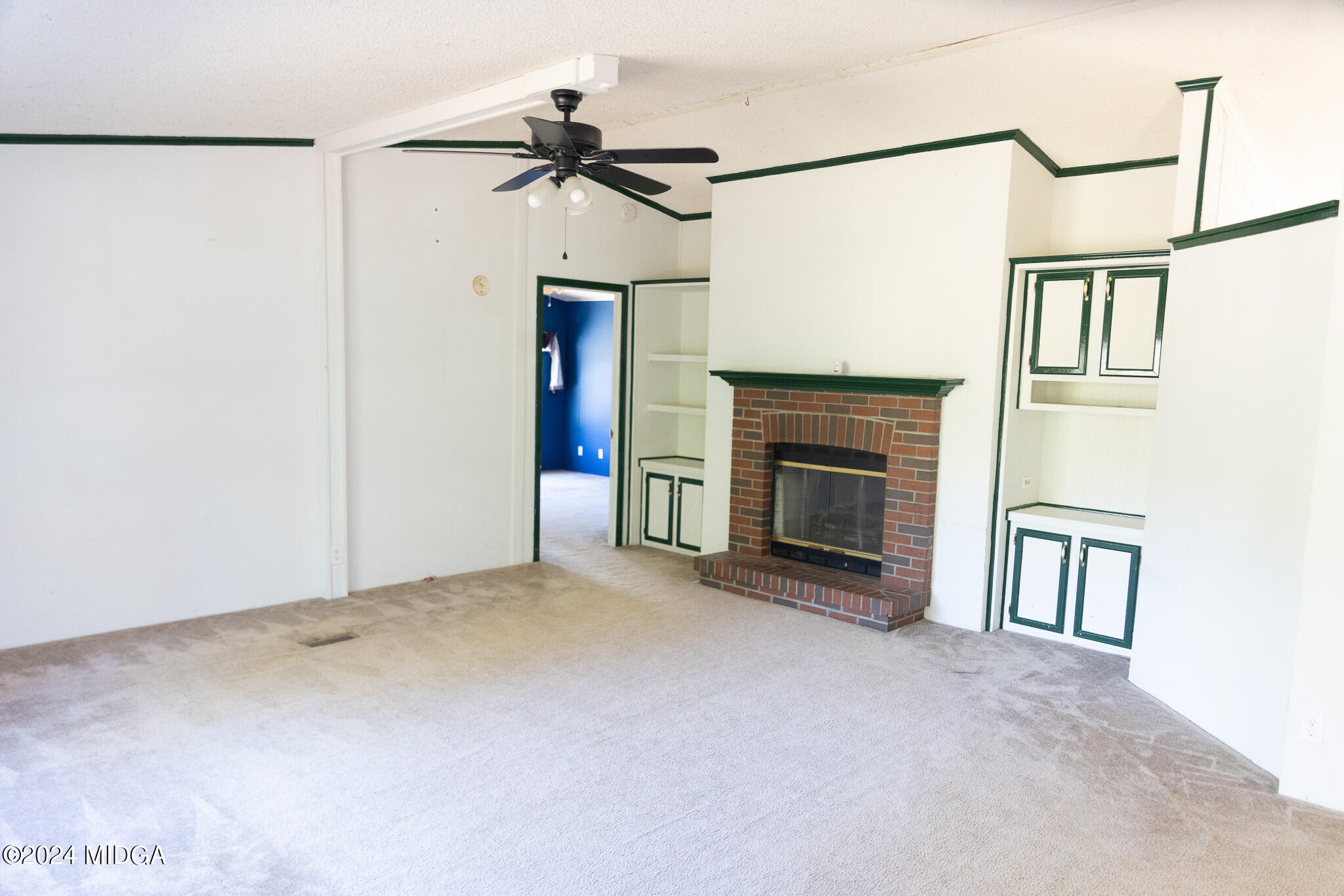 4687 Boxankle Road Jackson, GA 30233 - Photo 4 of 37 a view of empty room with fireplace and fan