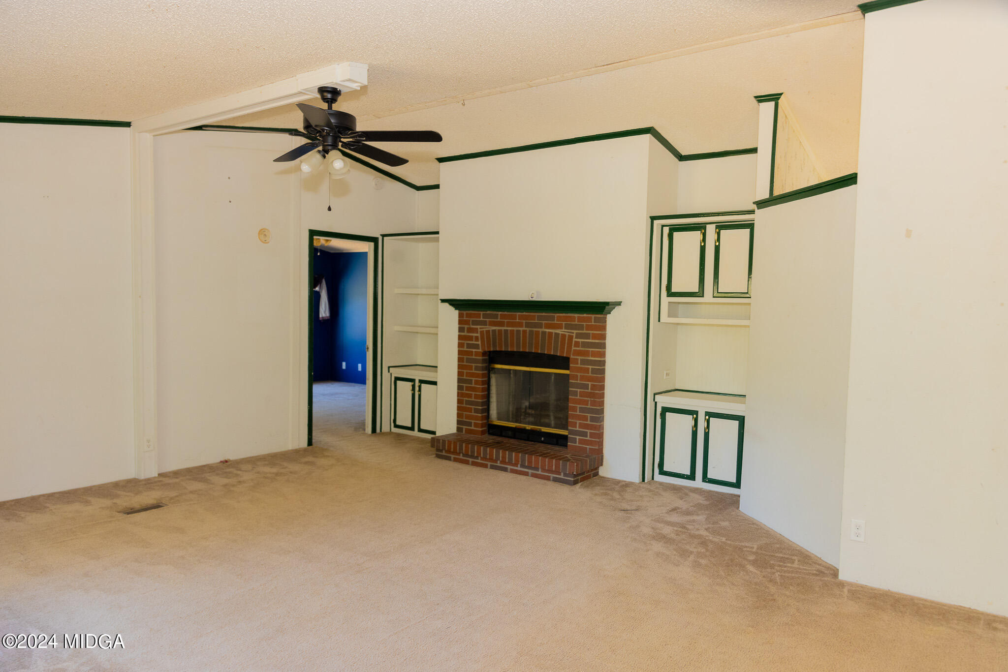 4687 Boxankle Road Jackson, GA 30233 - Photo 5 of 37 a view of a livingroom with a fireplace and a ceiling fan