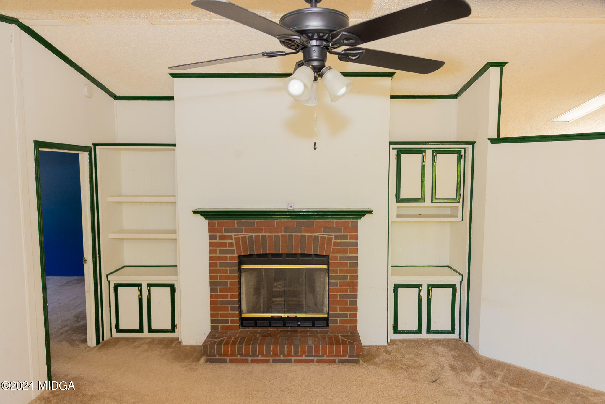 4687 Boxankle Road Jackson, GA 30233 - Photo 7 of 37 a living room with a fireplace and a ceiling fan