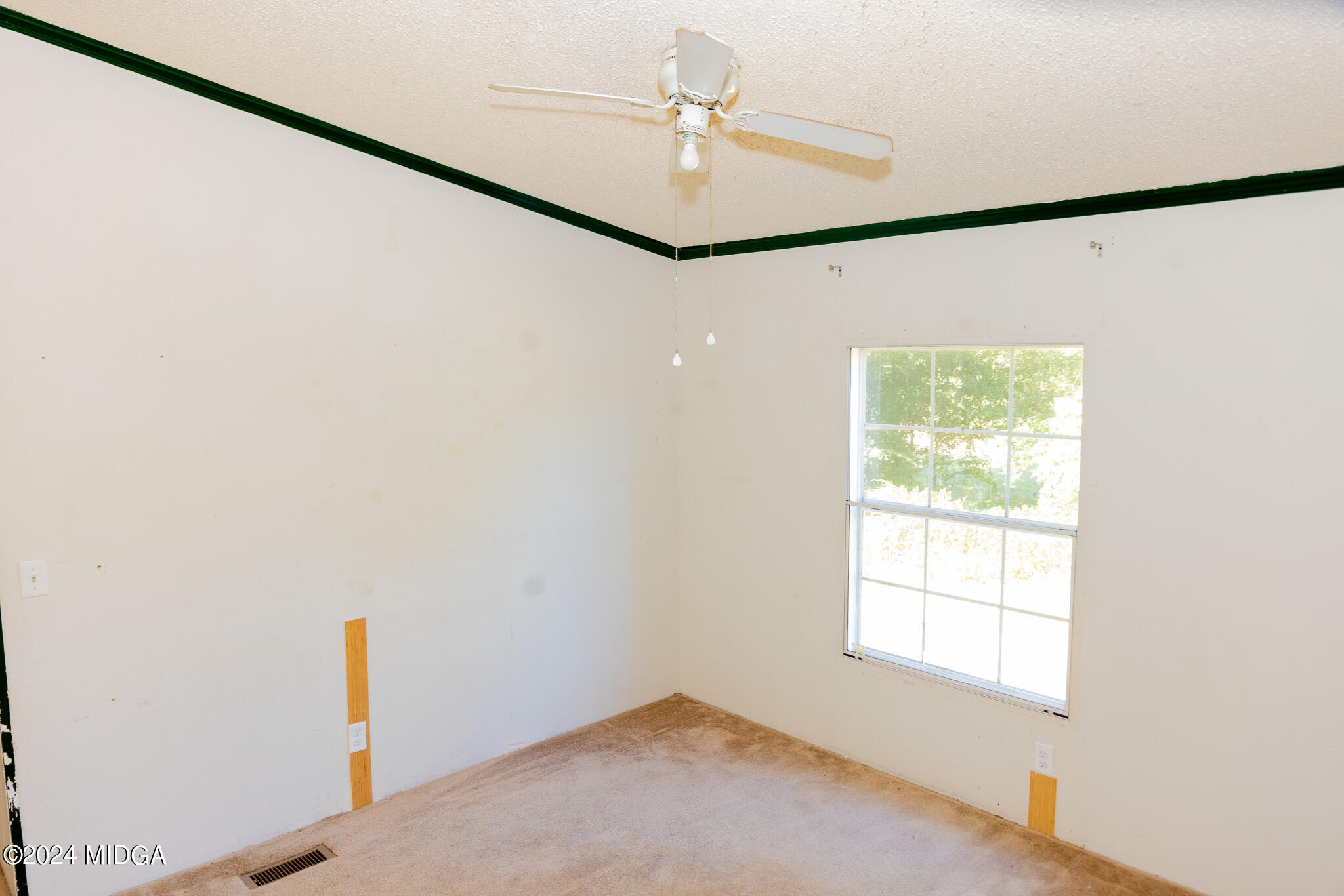 4687 Boxankle Road Jackson, GA 30233 - Photo 8 of 37 an empty room with a window and a ceiling fan