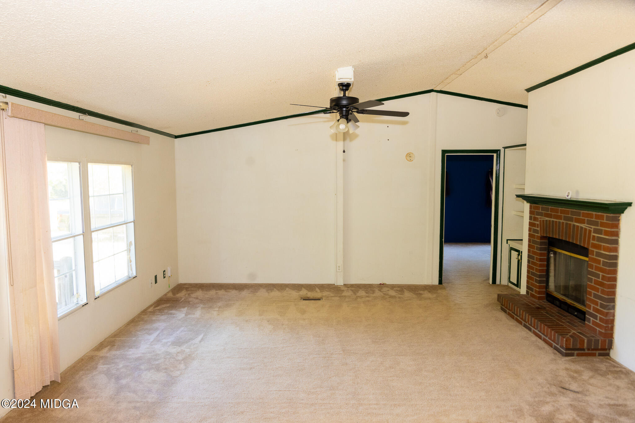 4687 Boxankle Road Jackson, GA 30233 - Photo 9 of 37 a view of an empty room with a fireplace and a window