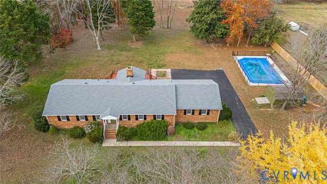 an aerial view of a house with garden space and street view