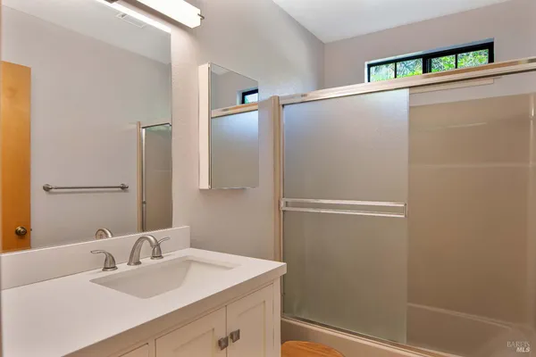 a bathroom with a sink and mirror