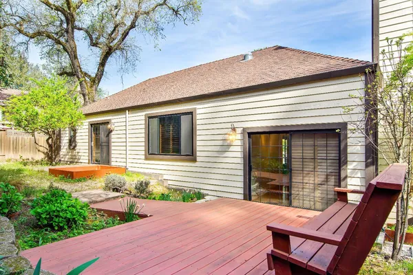 a view of a house with backyard and sitting area