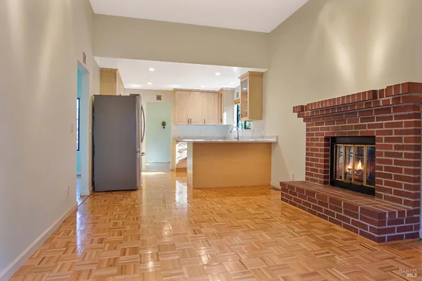 a view of an empty room and fire place