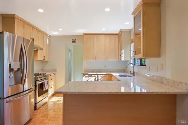 a kitchen with granite countertop a refrigerator and a sink