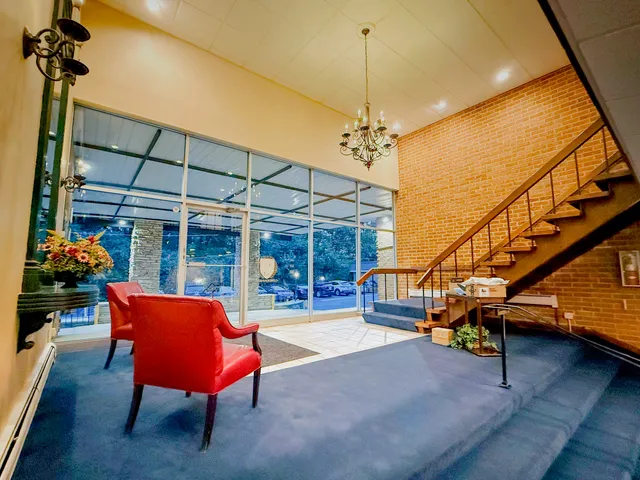 a bedroom with furniture and a chandelier