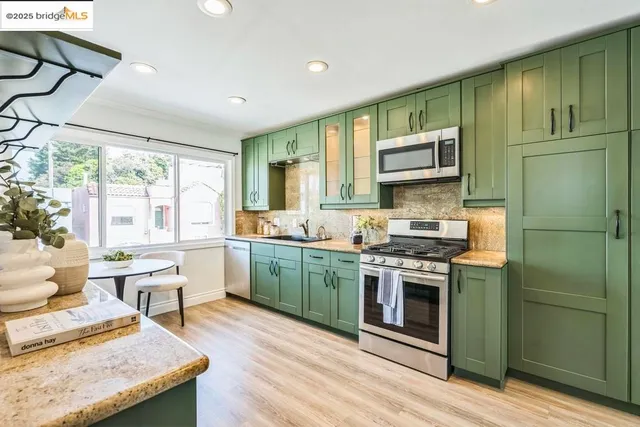 a kitchen with sink cabinets and wooden floor
